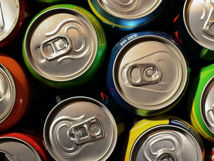 Assorted soda cans of different colors viewed from above