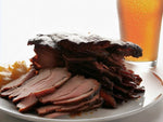 Corned beef brisket and ginger root beside ginger ale glass