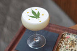 Martini glass with cannabis leaf decoration in cocktail foam