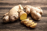 Sliced ginger root on wooden table