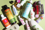 Hair products, lotions and other beauty products on green surface