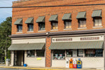 Middlesex Pharmacy with red brick exterior and green awnings