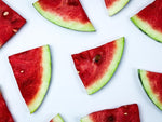 Watermelon slices on flat, white surface